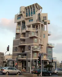 Large Building With A Clock On The Side Of It