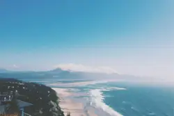 Beach With A View Of The Ocean And Mountains