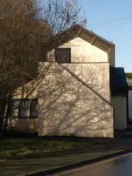 Small Building With A Large Brick Wall