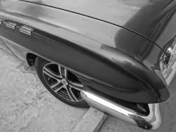 Black Car Parked On The Side Of A Road