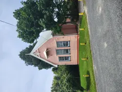 Small House With A Large Clock On The Front
