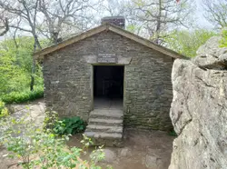 Small Stone Building With A Large Stone Wall