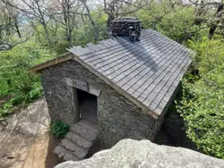 Stone Building With A Bench And A Stone Wall