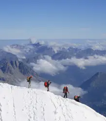 Three People Are Skiing Down A Mountain