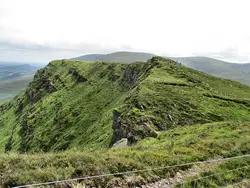 Large Hill With A Mountain Behind It