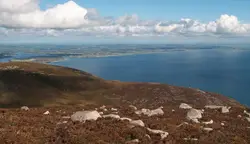 Rocky Hillside With A Mountain Range