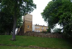 House With A Fence And A Building