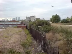 Train On A Train Track Near A Fence