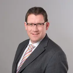 Man In A Suit And Tie Posing For A Picture