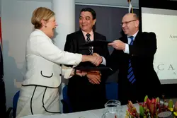 Man And Woman Are Standing In Front Of A Table