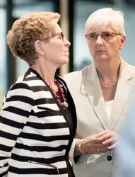 Woman And A Man Are Standing In A Room