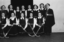 Large Group Of People Dressed In White Posing For A Picture
