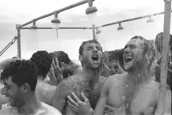 Crowd Of People Are Standing In The Water