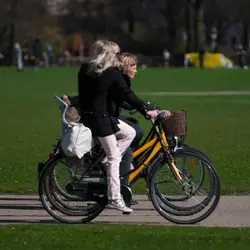 Woman Riding A Bike With A Child On It