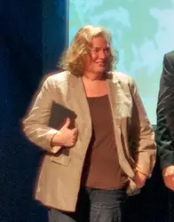 Man In A Suit And Tie Standing Next To A Woman