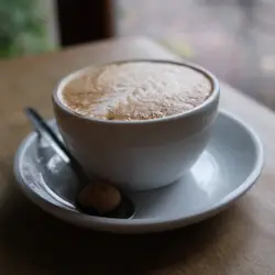 Cup Of Coffee On A Plate With A Spoon
