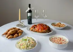 Table Topped With Plates Of Food And A Wine Glass