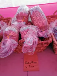 Pink Stuffed Animal Is Sitting On A Red Cloth