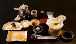 Table Topped With A Plate Of Food And A Cup Of Coffee