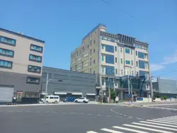 City Street With A Large Building And A Building