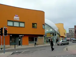 Woman Walking Down A Street With A Sign