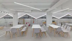 Room With A Large Table And Chairs And A Large Wall