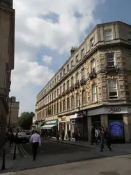 People Walking Down A Street In A City