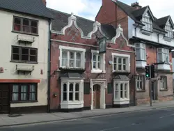 Brick Building With A Street Sign On The Side