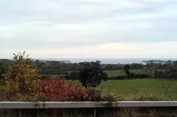 Fence Is Shown With A View Of A Field
