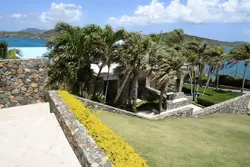 Large Green And White Beach With A Large Stone Wall