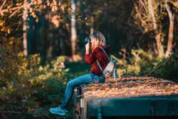 Person Is Sitting On A Bench And Holding A Book