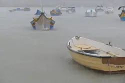 Small Boat Sitting On Top Of A Beach