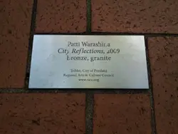 Sign On A Brick Wall With A Picture Of A Man