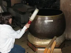 Woman Is Holding A Large Wooden Object