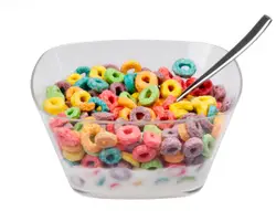 Bowl Of Assorted Doughnuts With A Spoon