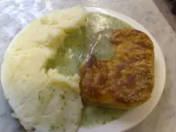 White Plate Topped With A Piece Of Meat And Broccoli