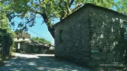 Brick Building With A Stone Wall And A Clock On The Side