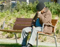 Man Sitting On A Bench With A Hat On