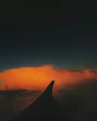 Plane Is Seen Through A Cloudy Sky