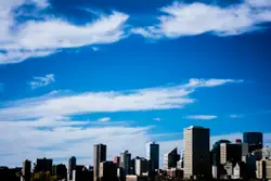 City With A Large Building And A Cloudy Sky