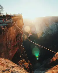 Person Is Jumping Over A Large Rock