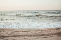 White Surfboard Is Standing On The Beach