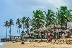 People Are Sitting On A Beach Near The Ocean