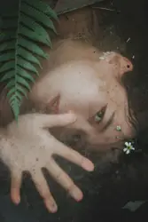 Person Is Standing In The Dirt With A Flower In Their Hand