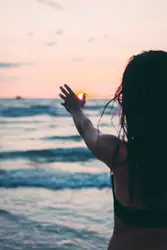 Woman Is Standing On The Beach With A Frisbee