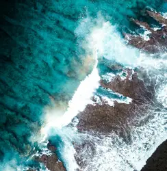 White Surfboard Is Floating On Top Of A Wave