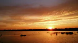Sunset With A Boat In The Water