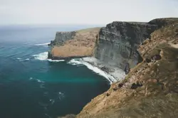 Large Rock Wall With A Mountain Range