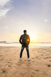 Man Standing On A Beach With A Frisbee