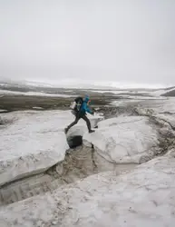 Man On A Snowboard Going Down A Hill